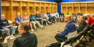 A group of people sitting in front of each other.