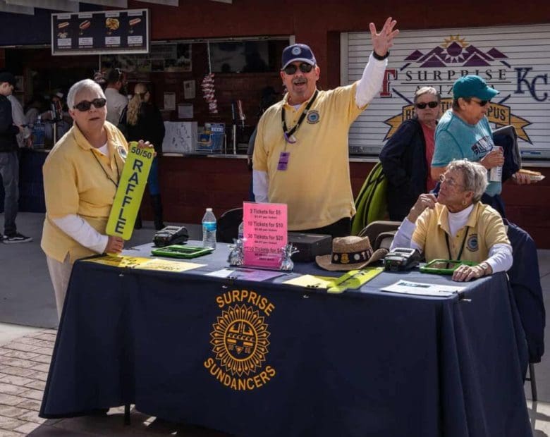 A group of people standing around a table.