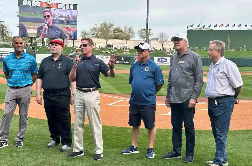 A group of men standing on top of a baseball field.