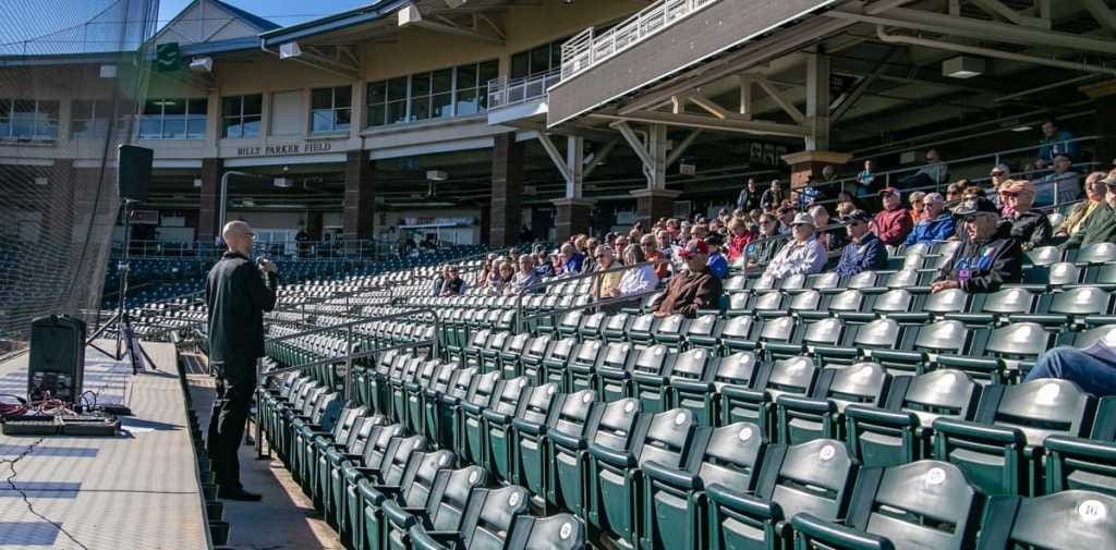 A group of people sitting in stadium seats.