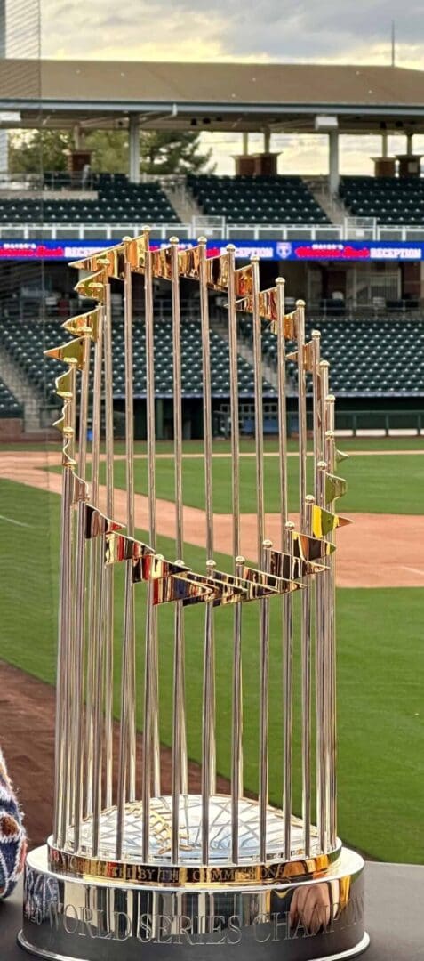 A baseball field with the world series trophy in the middle.