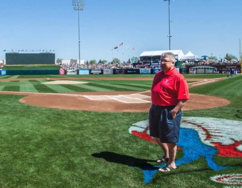 A man standing on top of a baseball field.