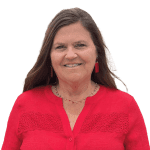 A woman in red shirt smiling for the camera.