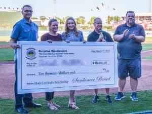 A group of people holding up a giant check.